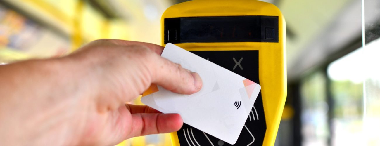 Automatic validator for reading and scanning ticket, cards and bank cards in public transport to pay for riding. Wireless contactless cashless payments, rfid nfc.