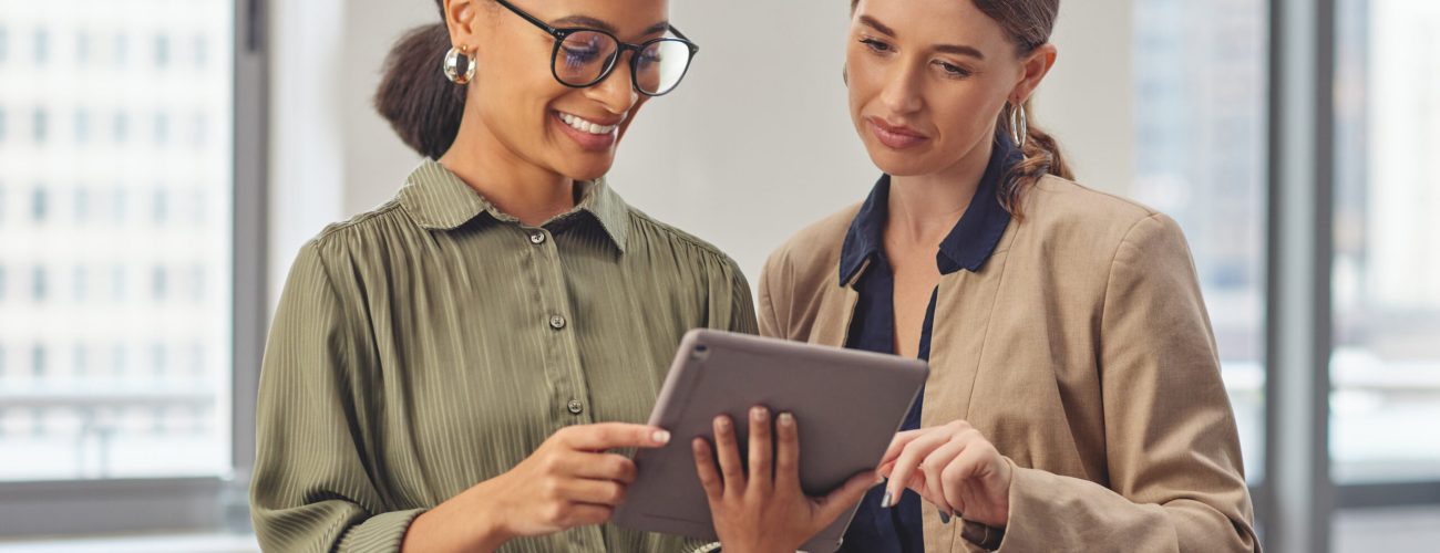 Business woman, team and discussion with tablet for news, research or online browsing at office. Female person or employees in conversation or meeting with technology for media or app at workplace.